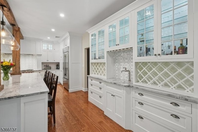 4 Knollwood Ln, Hardyston Twp, NJ 07460 - kitchen featuring stainless steel built in fridge, white cabinetry, wood finished floors, tasteful backsplash, and recessed lighting