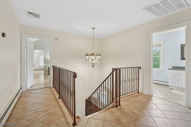 4 Knollwood Ln, Hardyston Twp, NJ 07460 - hallway with baseboard heating, an upstairs landing, a chandelier, and light tile patterned flooring