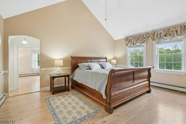 4 Knollwood Ln, Hardyston Twp, NJ 07460 - bedroom featuring a baseboard heating unit, high vaulted ceiling, light wood-style flooring, and arched walkways