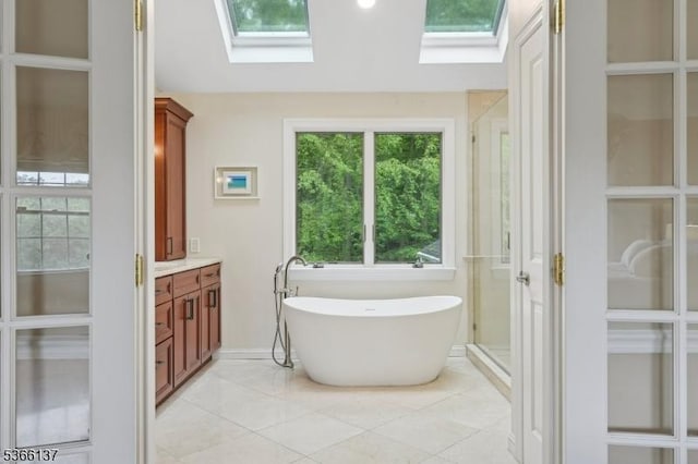 4 Knollwood Ln, Hardyston Twp, NJ 07460 - bathroom featuring a skylight, a soaking tub, vanity, and tile patterned floors