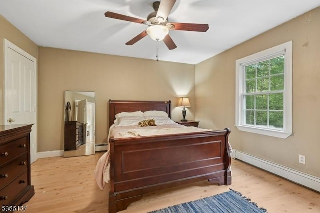 4 Knollwood Ln, Hardyston Twp, NJ 07460 - bedroom featuring a baseboard heating unit, light wood-style floors, baseboard heating, and a ceiling fan