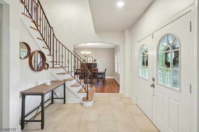 4 Knollwood Ln, Hardyston Twp, NJ 07460 - entrance foyer featuring arched walkways, stairs, a baseboard heating unit, a chandelier, and french doors