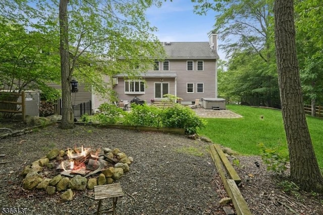 4 Knollwood Ln, Hardyston Twp, NJ 07460 - back of property featuring a fire pit, a hot tub, a chimney, and a patio