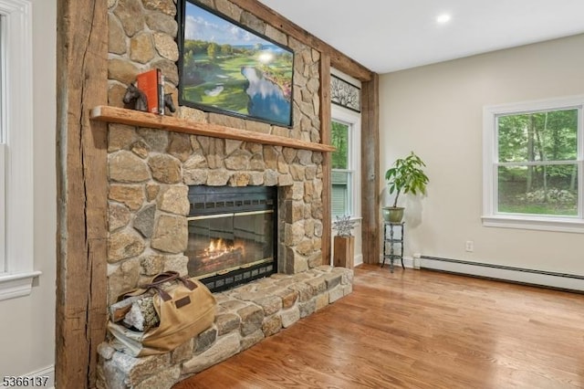 4 Knollwood Ln, Hardyston Twp, NJ 07460 - living room featuring a stone fireplace, wood finished floors, baseboard heating, healthy amount of natural light, and recessed lighting