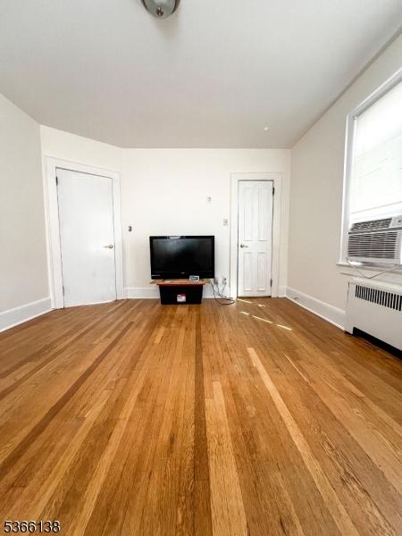 453 Beardsley Ave, Bloomfield Twp, NJ 07003 - unfurnished living room featuring wood finished floors and radiator