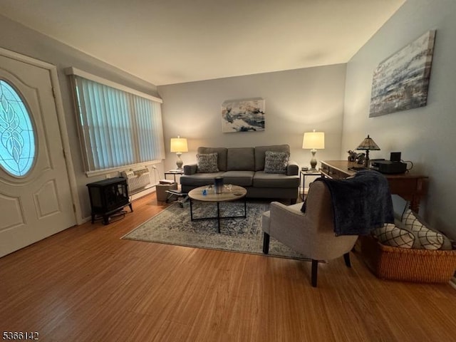 472B Thornbury Ct, Lakewood Twp, NJ 08701 - living area with wood finished floors and a wood stove