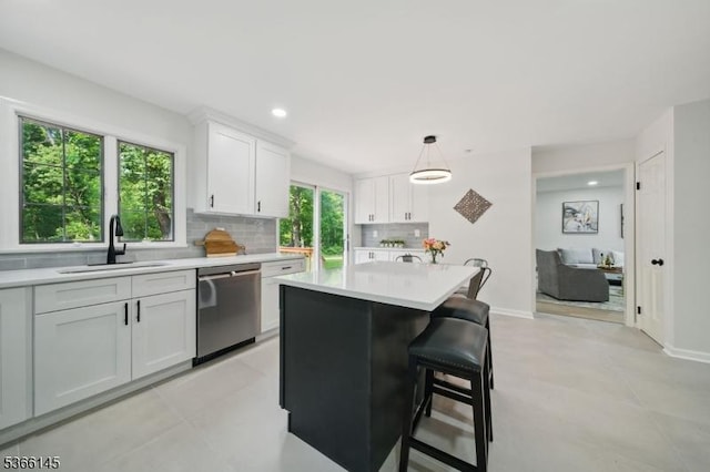 463 Garretson Rd, Bridgewater Twp, NJ 08807 - kitchen featuring dishwasher, light countertops, tasteful backsplash, white cabinetry, and a kitchen breakfast bar