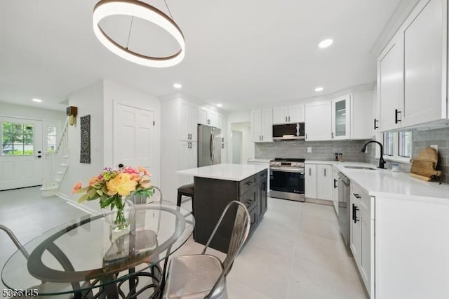 463 Garretson Rd, Bridgewater Twp, NJ 08807 - kitchen with stainless steel appliances, light countertops, backsplash, white cabinetry, and recessed lighting