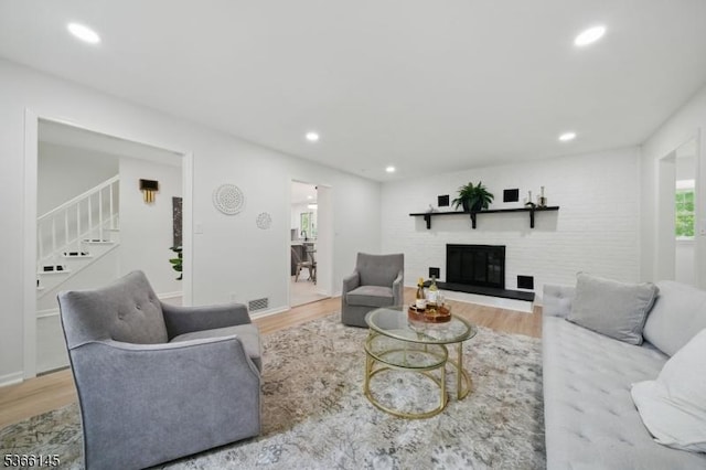 463 Garretson Rd, Bridgewater Twp, NJ 08807 - living area with wood finished floors, stairway, a glass covered fireplace, and recessed lighting