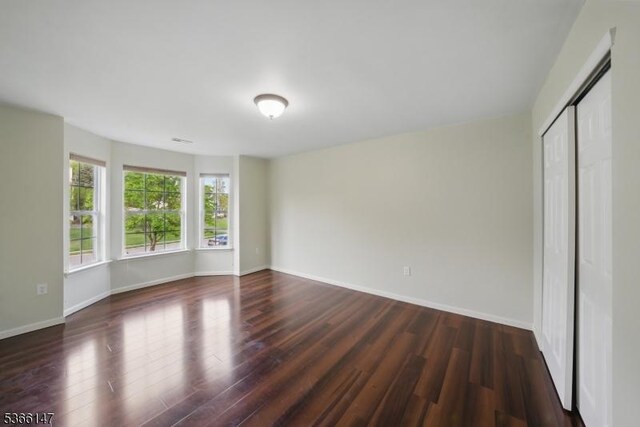 43 Saunders Ln, Mount Olive Twp, NJ 07840 - unfurnished bedroom with dark wood-type flooring and a closet