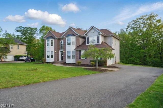 43 Saunders Ln, Mount Olive Twp, NJ 07840 - view of front facade featuring asphalt driveway, an attached garage, and a front lawn