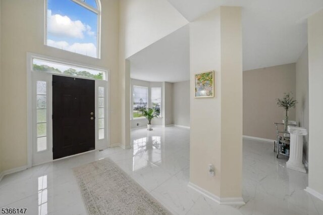 43 Saunders Ln, Mount Olive Twp, NJ 07840 - foyer featuring light marble finish floors and a towering ceiling