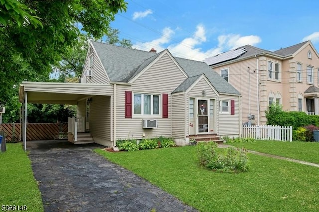 26 Mitchell St, Belleville Twp, NJ 07109 - view of front facade with driveway, a shingled roof, entry steps, an attached carport, and a wall mounted AC