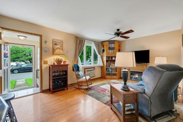 26 Mitchell St, Belleville Twp, NJ 07109 - living room with a ceiling fan, wood finished floors, an AC wall unit, and a glass covered fireplace