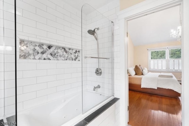 52 E Ave, Washington Twp, NJ 07840 - bathroom with connected bathroom, tiled shower / bath, wood finished floors, and a chandelier