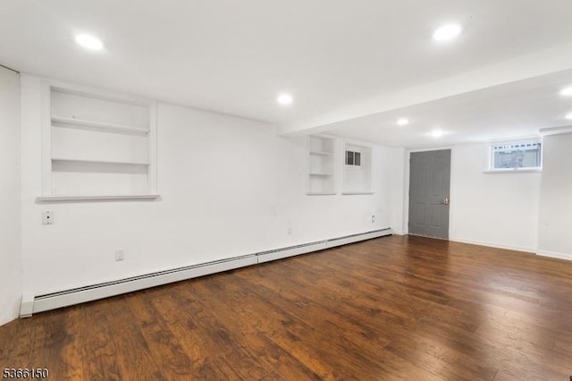 52 E Ave, Washington Twp, NJ 07840 - below grade area featuring a baseboard heating unit, wood finished floors, recessed lighting, and built in shelves