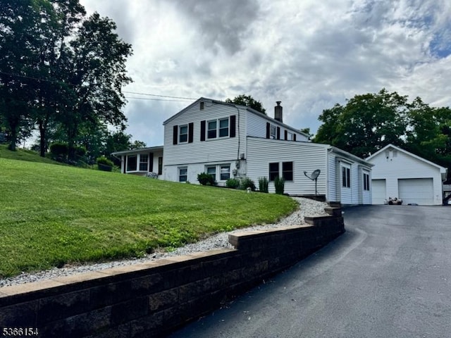 105 Rolling Acres Dr, Hampton Twp, NJ 07860 - view of front of house featuring an outbuilding, a chimney, a detached garage, and a front yard