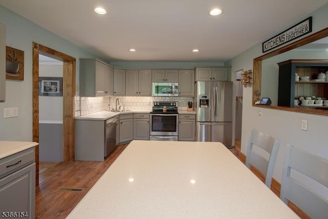 105 Rolling Acres Dr, Hampton Twp, NJ 07860 - kitchen featuring stainless steel appliances, gray cabinetry, light countertops, decorative backsplash, and recessed lighting