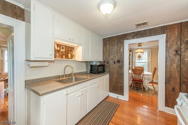 6 Mc Clintock Pl, Parsippany-Troy Hills Twp, NJ 07878 - kitchen featuring black microwave, range, light wood finished floors, ornamental molding, and white cabinets