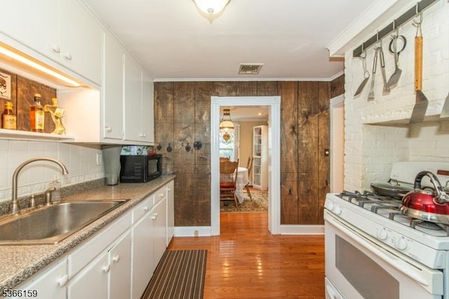 6 Mc Clintock Pl, Parsippany-Troy Hills Twp, NJ 07878 - kitchen with gas range gas stove, light wood-style flooring, white cabinets, tasteful backsplash, and black microwave