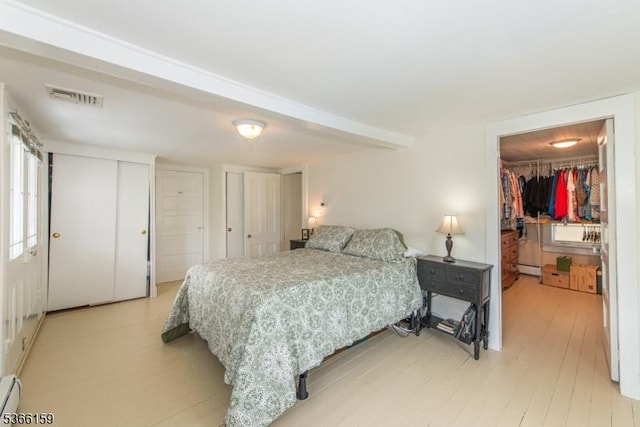 6 Mc Clintock Pl, Parsippany-Troy Hills Twp, NJ 07878 - bedroom featuring a baseboard radiator, light wood-style flooring, multiple closets, and a spacious closet