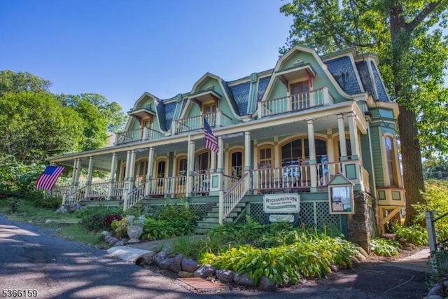 6 Mc Clintock Pl, Parsippany-Troy Hills Twp, NJ 07878 - victorian-style house with covered porch, stairway, mansard roof, and a balcony