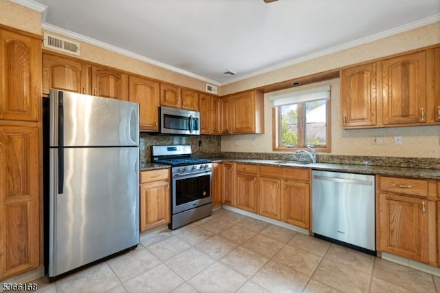 3 Casey Ave, East Hanover Twp, NJ 07936 - kitchen with stainless steel appliances, brown cabinets, crown molding, dark stone counters, and tasteful backsplash