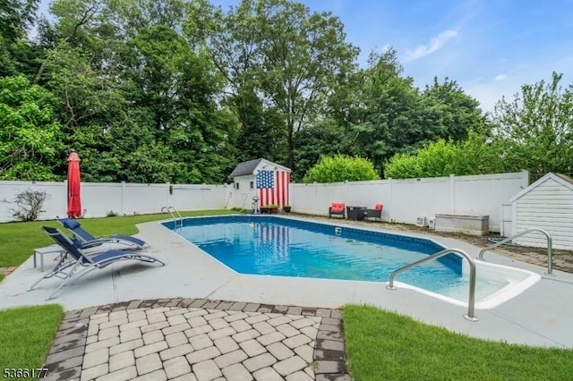 24 Roxbury Dr, Roxbury Twp, NJ 07847 - view of swimming pool featuring a storage unit, a patio area, a fenced backyard, and view of wooded area