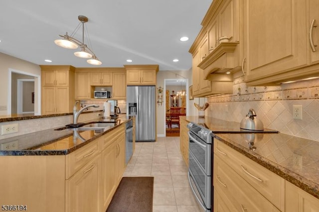2 Kerry Pl, Mount Olive Twp, NJ 07836 - kitchen with stainless steel appliances, light tile patterned floors, dark stone counters, backsplash, and recessed lighting