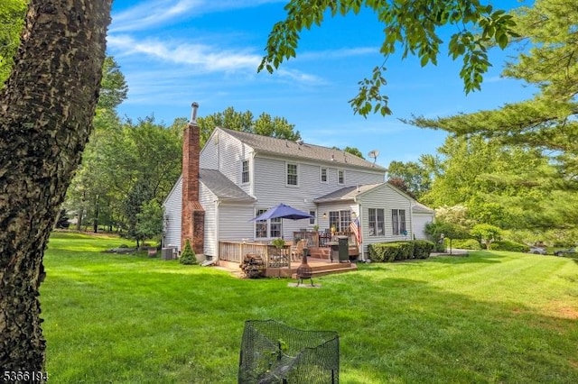 2 Kerry Pl, Mount Olive Twp, NJ 07836 - rear view of house featuring a wooden deck, a lawn, and a chimney