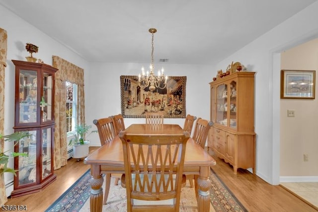2 Kerry Pl, Mount Olive Twp, NJ 07836 - dining space featuring a chandelier, light wood-style flooring, and a baseboard heating unit