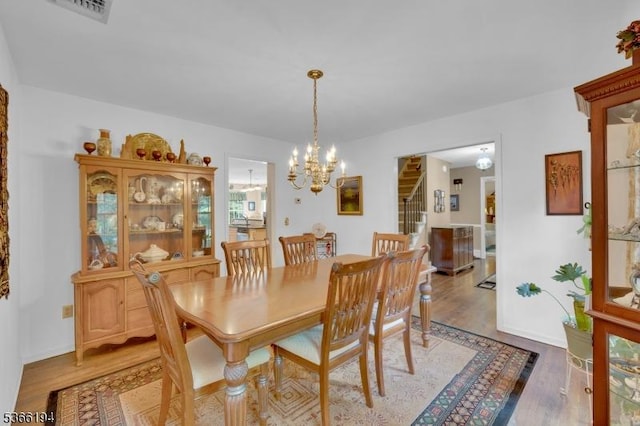 2 Kerry Pl, Mount Olive Twp, NJ 07836 - dining space with stairs, a chandelier, and light wood-type flooring