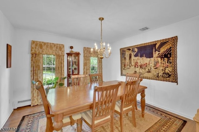 2 Kerry Pl, Mount Olive Twp, NJ 07836 - dining space with a baseboard radiator, a chandelier, and wood finished floors