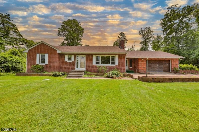 76 Hawks Schoolhouse Rd, Holland Twp, NJ 08804 - ranch-style house with an attached garage, a front lawn, brick siding, and a chimney
