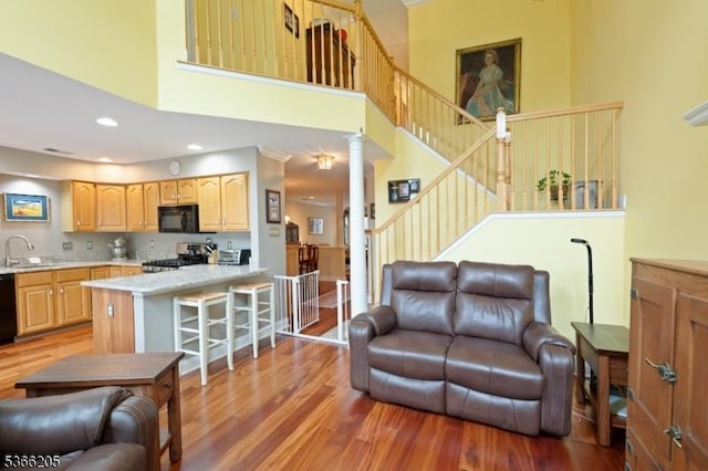 1305 S Branch Dr, Readington Twp, NJ 08889 - living area with a towering ceiling, light wood-type flooring, decorative columns, stairway, and recessed lighting