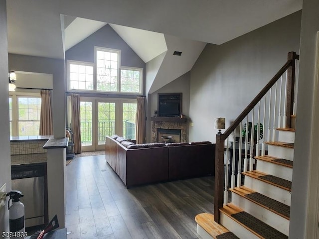 1-23 Pine Cres Unit 23, Vernon Twp, NJ 07462 - living area with a stone fireplace, wood finished floors, stairs, and high vaulted ceiling