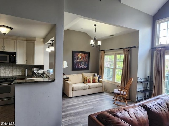 1-23 Pine Cres Unit 23, Vernon Twp, NJ 07462 - living room with lofted ceiling, a chandelier, and wood finished floors