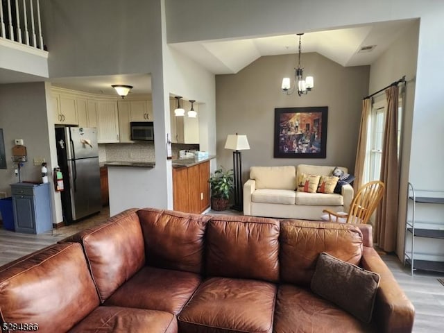 1-23 Pine Cres Unit 23, Vernon Twp, NJ 07462 - living area with light wood finished floors, a chandelier, and vaulted ceiling