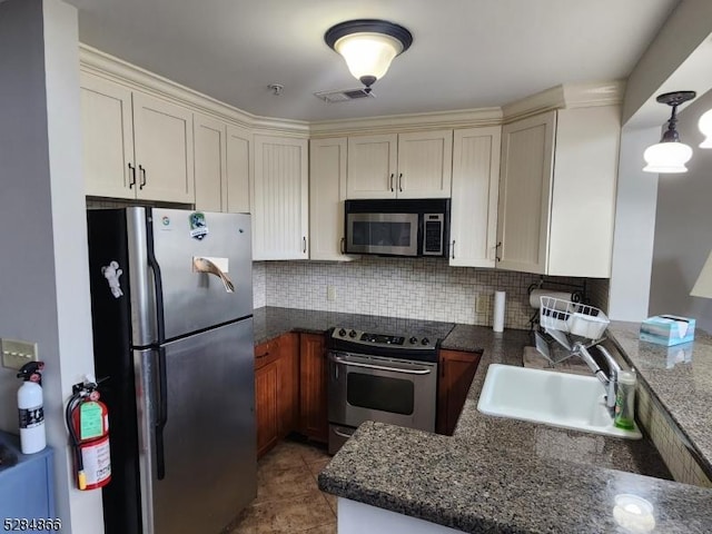 1-23 Pine Cres Unit 23, Vernon Twp, NJ 07462 - kitchen featuring appliances with stainless steel finishes, a peninsula, tasteful backsplash, light tile patterned floors, and dark stone countertops