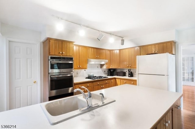 33 Kings Hwy, Washington Twp, NJ 07853 - kitchen featuring freestanding refrigerator, rail lighting, stainless steel double oven, gas stovetop, and light countertops