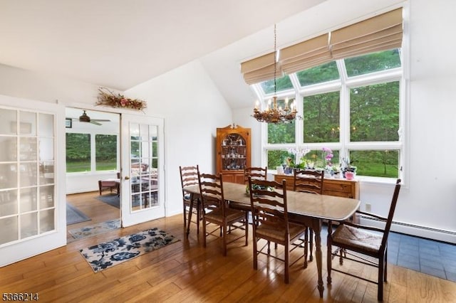 33 Kings Hwy, Washington Twp, NJ 07853 - dining space featuring a chandelier, french doors, wood finished floors, a baseboard heating unit, and vaulted ceiling