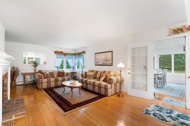 33 Kings Hwy, Washington Twp, NJ 07853 - living area with light wood-type flooring and a brick fireplace