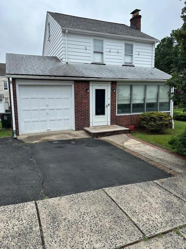 4 Hampton Pl, Nutley Twp, NJ 07110 - view of front facade featuring brick siding, a garage, a chimney, driveway, and a shingled roof