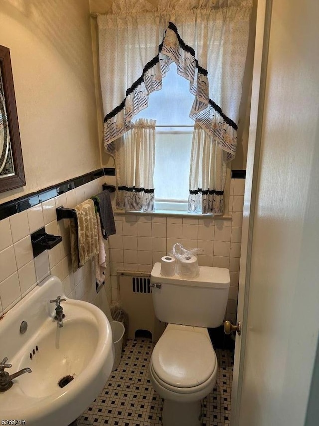 4 Hampton Pl, Nutley Twp, NJ 07110 - bathroom featuring tile walls, radiator heating unit, and a wainscoted wall
