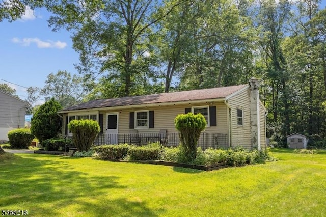 15 Stony Brook Rd, Byram Twp, NJ 07874 - view of front of house with a front lawn, a chimney, and a shed
