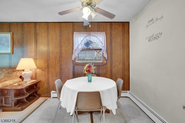 15 Stony Brook Rd, Byram Twp, NJ 07874 - dining area featuring baseboard heating, ceiling fan, light tile patterned flooring, wood walls, and a baseboard radiator
