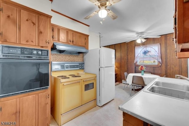 15 Stony Brook Rd, Byram Twp, NJ 07874 - kitchen with white appliances, under cabinet range hood, a ceiling fan, brown cabinets, and wood walls