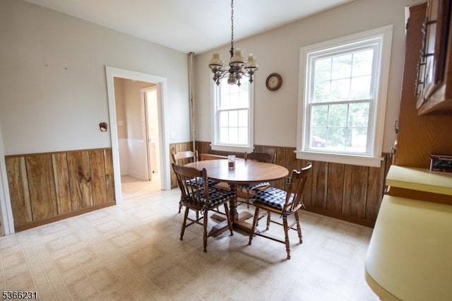 48 Keller Ave, Rockaway Boro, NJ 07866 - dining area featuring a wainscoted wall, light flooring, a chandelier, and wooden walls