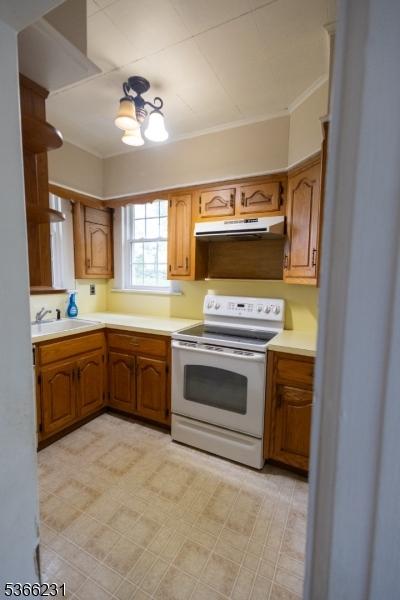 48 Keller Ave, Rockaway Boro, NJ 07866 - kitchen featuring white range with electric stovetop, under cabinet range hood, ornamental molding, light countertops, and brown cabinetry