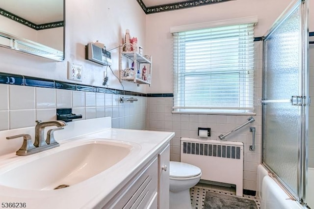 21 Academy Ter, Linden City, NJ 07036 - bathroom with radiator heating unit, vanity, tile walls, enclosed tub / shower combo, and wainscoting